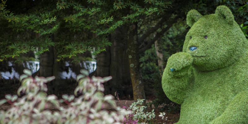 Green bear sculpture in gardens